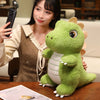 A cute green dinosaur plush toy is displayed on a wooden table next to a person.