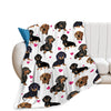 A white flannel blanket featuring a repeating pattern of various brown and black dachshund dogs.