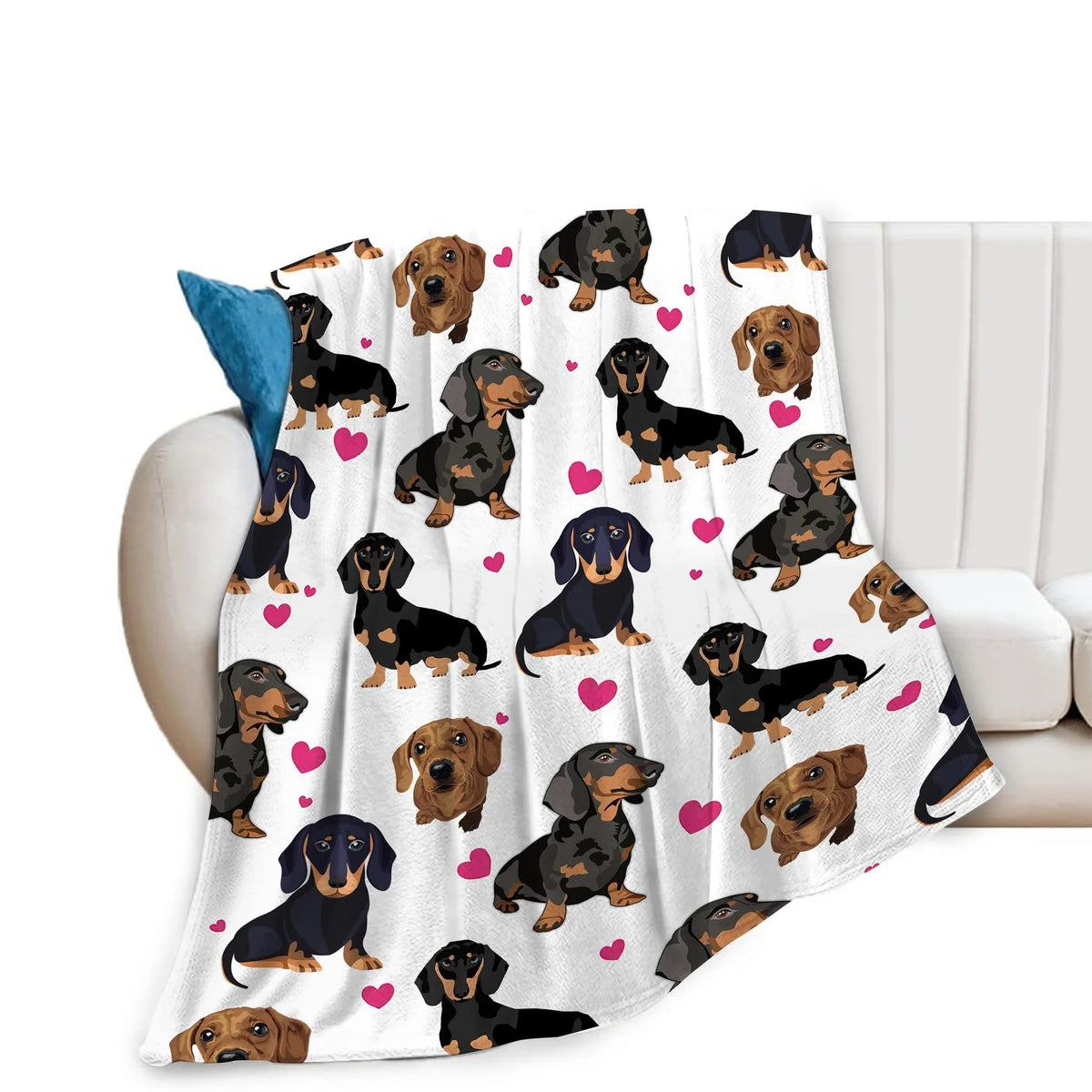 A white flannel blanket featuring a repeating pattern of various brown and black dachshund dogs.
