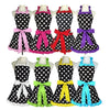 A set of five retro polka dot ruffle aprons in various colors including pink, black, red, and purple.