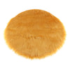 Round orange faux fur sheepskin area rug with a fluffy texture.
