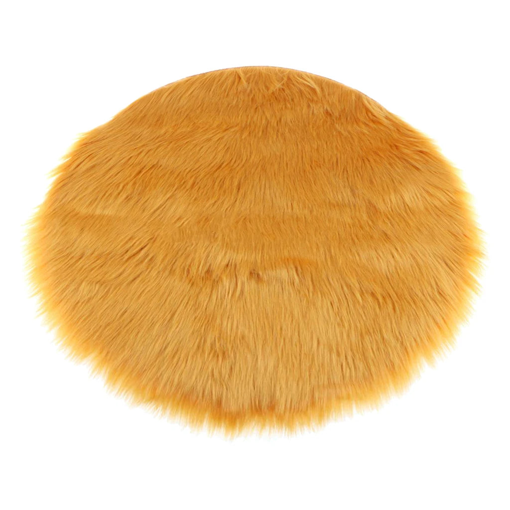 Round orange faux fur sheepskin area rug with a fluffy texture.
