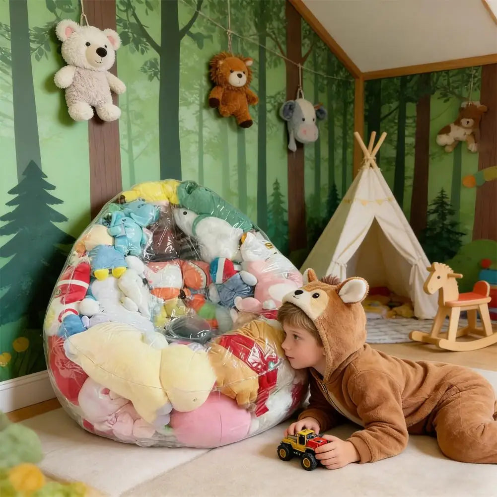 A child is sitting next to a large transparent inflatable storage bag filled with various plush toys in a room decorated with