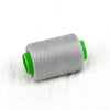 A roll of gray sewing thread with a bright green core.