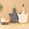 A gray and white cartoon goose hanging hand towel with a yellow beak and feet.