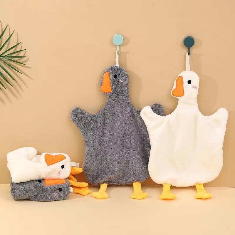 A gray and white cartoon goose hanging hand towel with a yellow beak and feet.