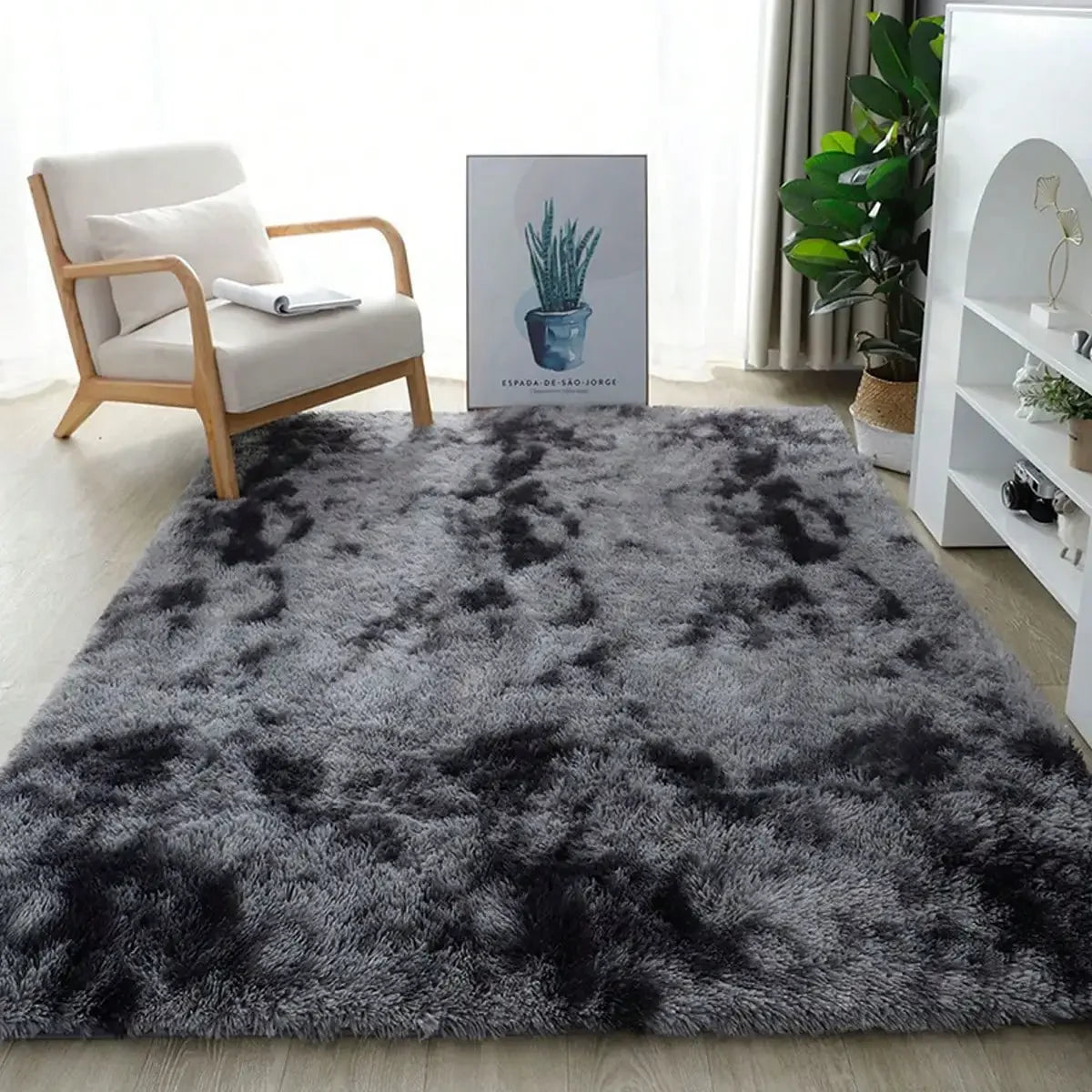 A plush, long-pile area rug in dark gray and black with a fluffy texture placed on a light wooden floor.