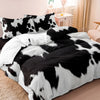 Black and white cow print yak leather duvet cover set displayed on a bed.