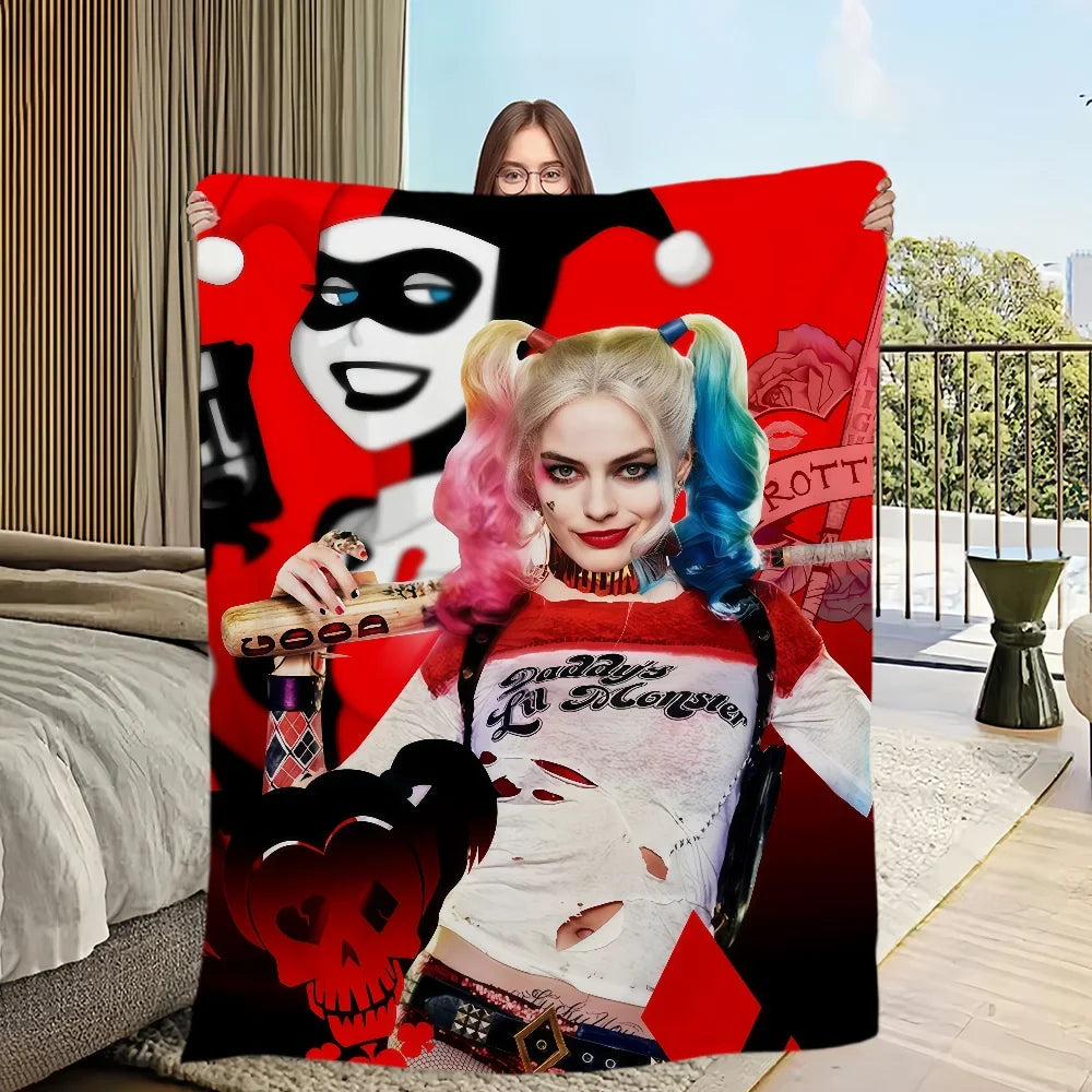 A woman with pink and blue hair wearing a white shirt is featured on a red blanket design.