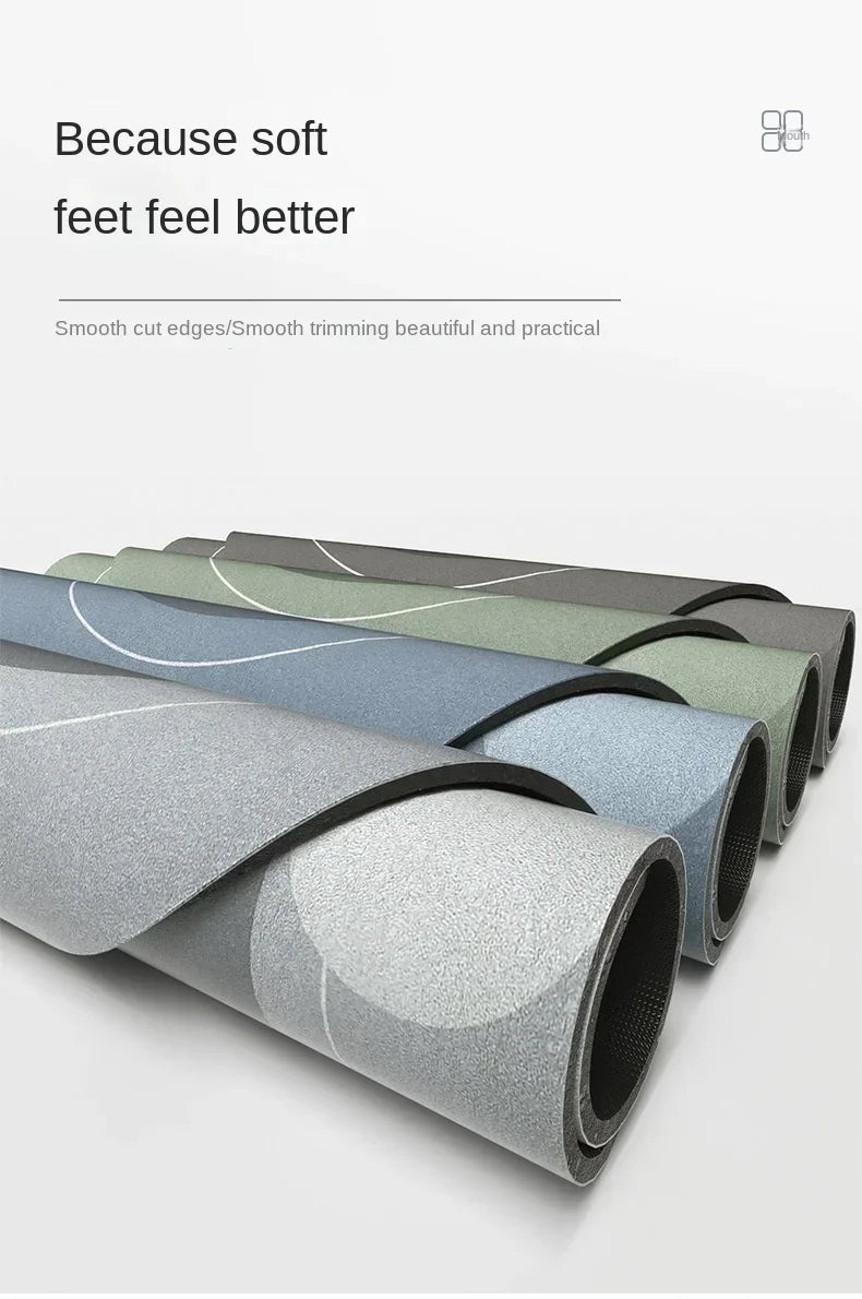 Rolls of diatom mud floor mats in various shades of gray and green, showing smooth cut edges.