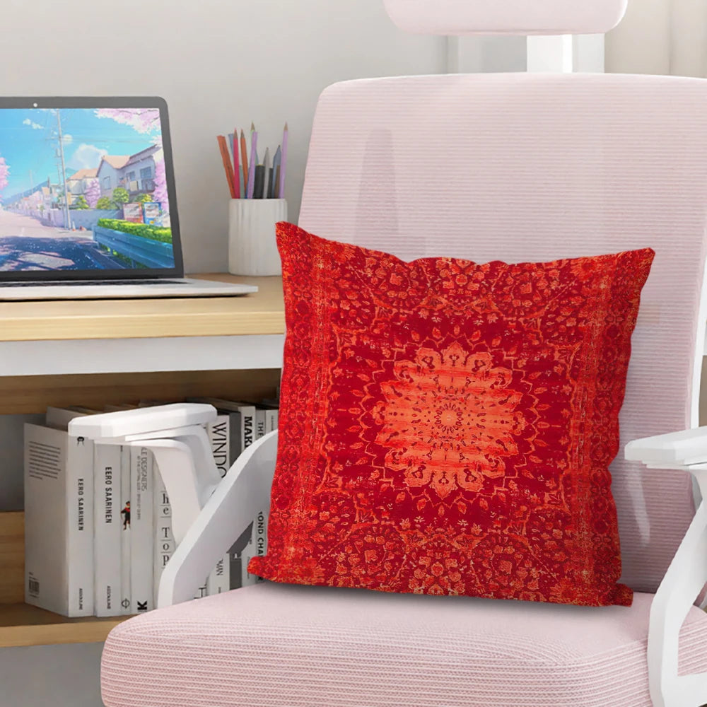 A vibrant red Persian pattern decorative cushion cover resting on a pink chair.