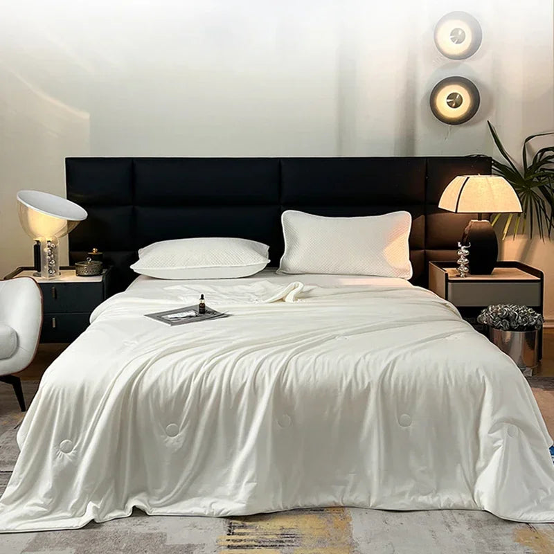 A luxurious bedroom featuring a bed with white linens and dark headboard, illuminated by modern wall sconces.