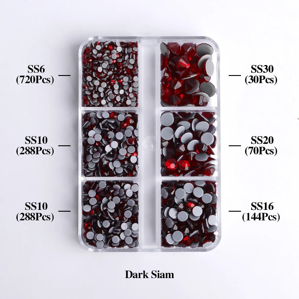 A clear plastic tray containing various sizes of dark glass rhinestones in different colors and quantities.