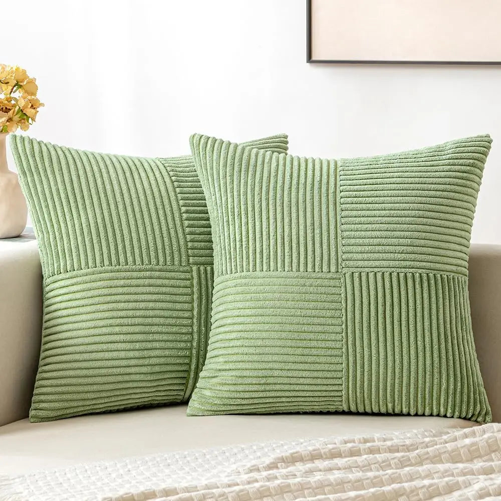 A set of four light green corduroy throw pillow covers with a vertical ribbed texture and patchwork design.