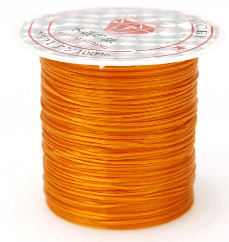 A spool of bright orange multicolor elastic beading cord with a white and red patterned label.