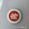 Red embroidered patch with the text Nuka Cola on a white background.