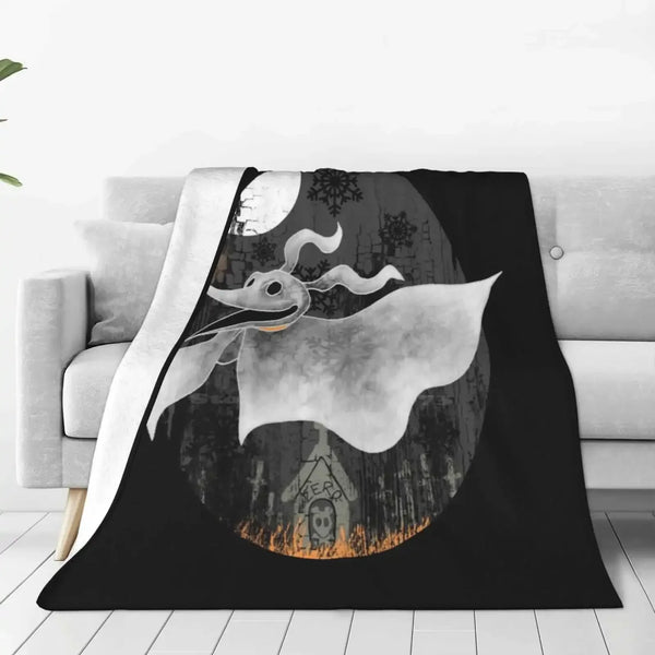 A black throw blanket featuring a silhouette of a bat-like creature and a gothic building against a moonlit background.