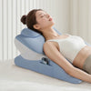 A woman is resting her eyes on a large blue memory foam body pillow for comfort.