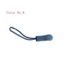 A close-up of a blue replacement zipper pull for bags and apparel.
