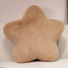 A beige star-shaped decorative throw pillow with a fluffy texture.