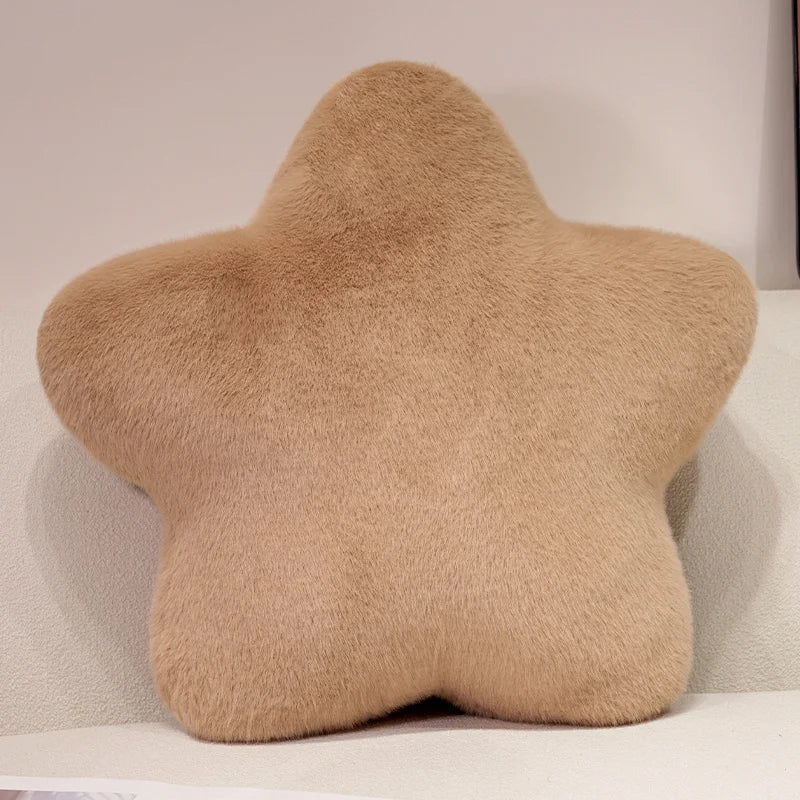 A beige star-shaped decorative throw pillow with a fluffy texture.