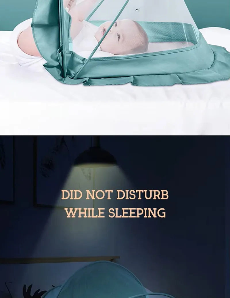 A close-up of a teal foldable mosquito net covering an infant sleeping in a crib.