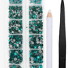 A clear plastic case containing a set of green and blue crystal hot fix rhinestones with an applicator tool.