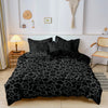 A black leopard print duvet cover set displayed on a bed in a bright room.
