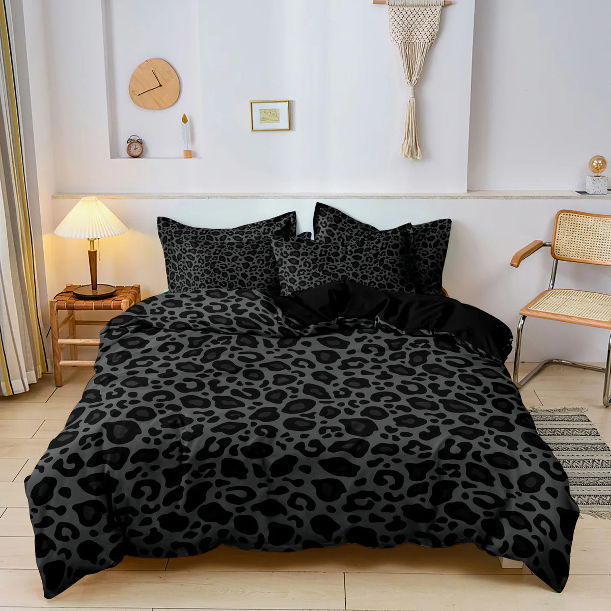 A black leopard print duvet cover set displayed on a bed in a bright room.