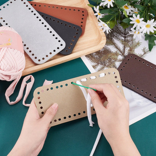 Hands are assembling a set of four square woven bag hanging hooks in various earth tones on a wooden board.
