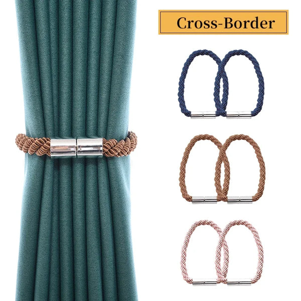 Close-up of a teal curtain with magnetic cross-border tieback clips in blue and brown colors