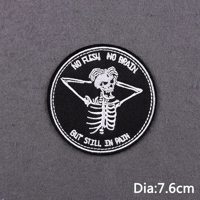 Black embroidered patch featuring a skull design with the text No Flesh No Brain But Still In Pain