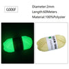 A spool of bright green glow-in-the-dark polyester yarn labeled G006F for knitting and crochet.