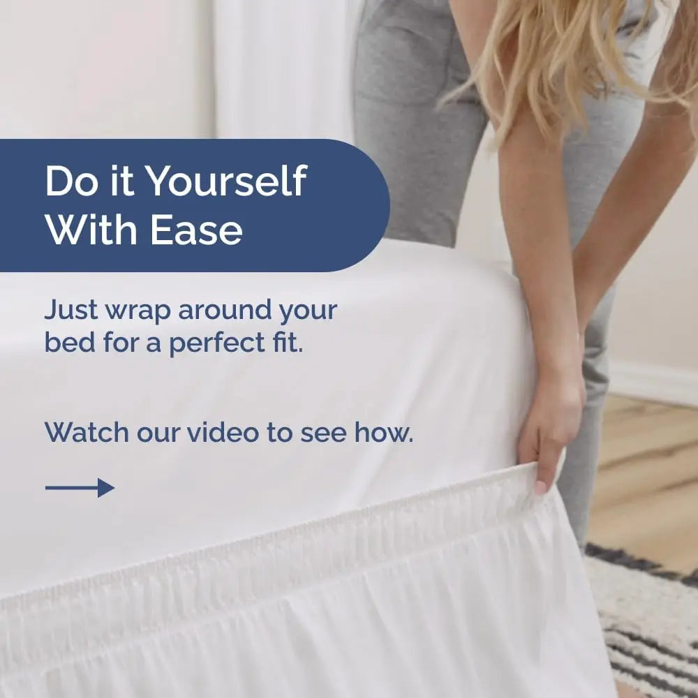 A person is wrapping an elegant ruffled bed skirt around a bed for a perfect fit.