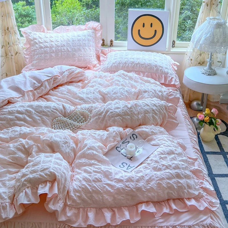 A pink lace seersucker duvet cover set displayed on a bed with natural light and decorative pillows.