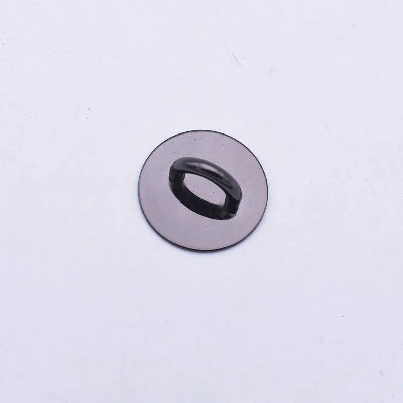 A round, silver-colored metal connector with a small oval opening.