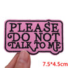 Pink embroidered letter iron-on patch with the text PLEASE DO NOT TALK TO ME