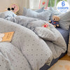 A set of light blue and gray microfiber duvet covers and pillowcases with a teddy bear toy.