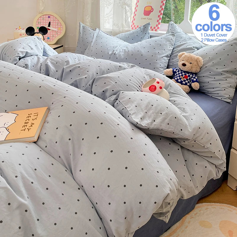A set of light blue and gray microfiber duvet covers and pillowcases with a teddy bear toy.