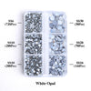 A clear plastic container holding various sizes of silver and iridescent opal glass rhinestones.