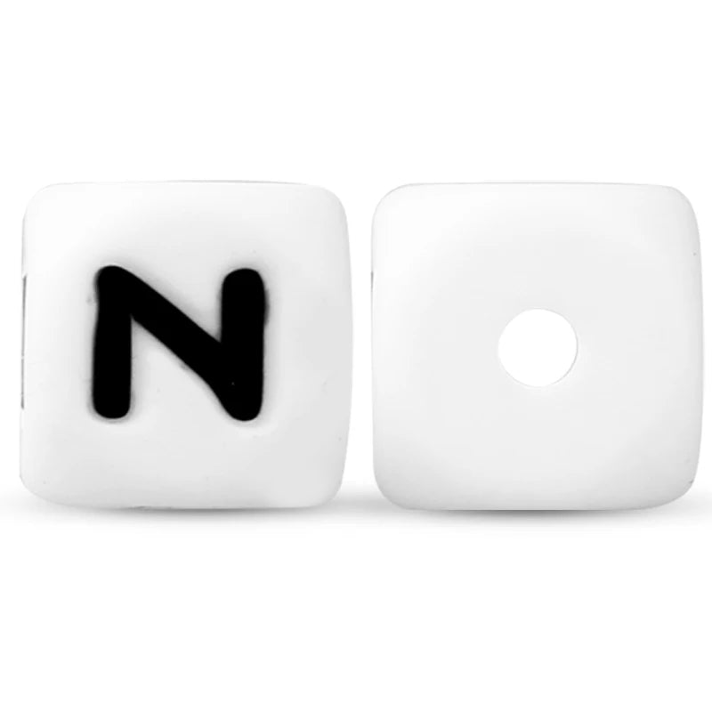 A white silicone alphabet bead shaped like the letter N with a circular hole.