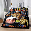 A black graphic throw blanket featuring portraits of music artists with the text All Eyes On Mile.