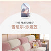 A modern, light pink and white sectional sofa with a full backrest and neutral upholstery.