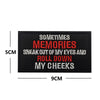 Black embroidered patch with red text saying Sometimes Memories sneak out of my eyes and roll down my cheeks