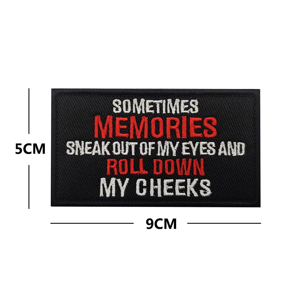 Black embroidered patch with red text saying Sometimes Memories sneak out of my eyes and roll down my cheeks