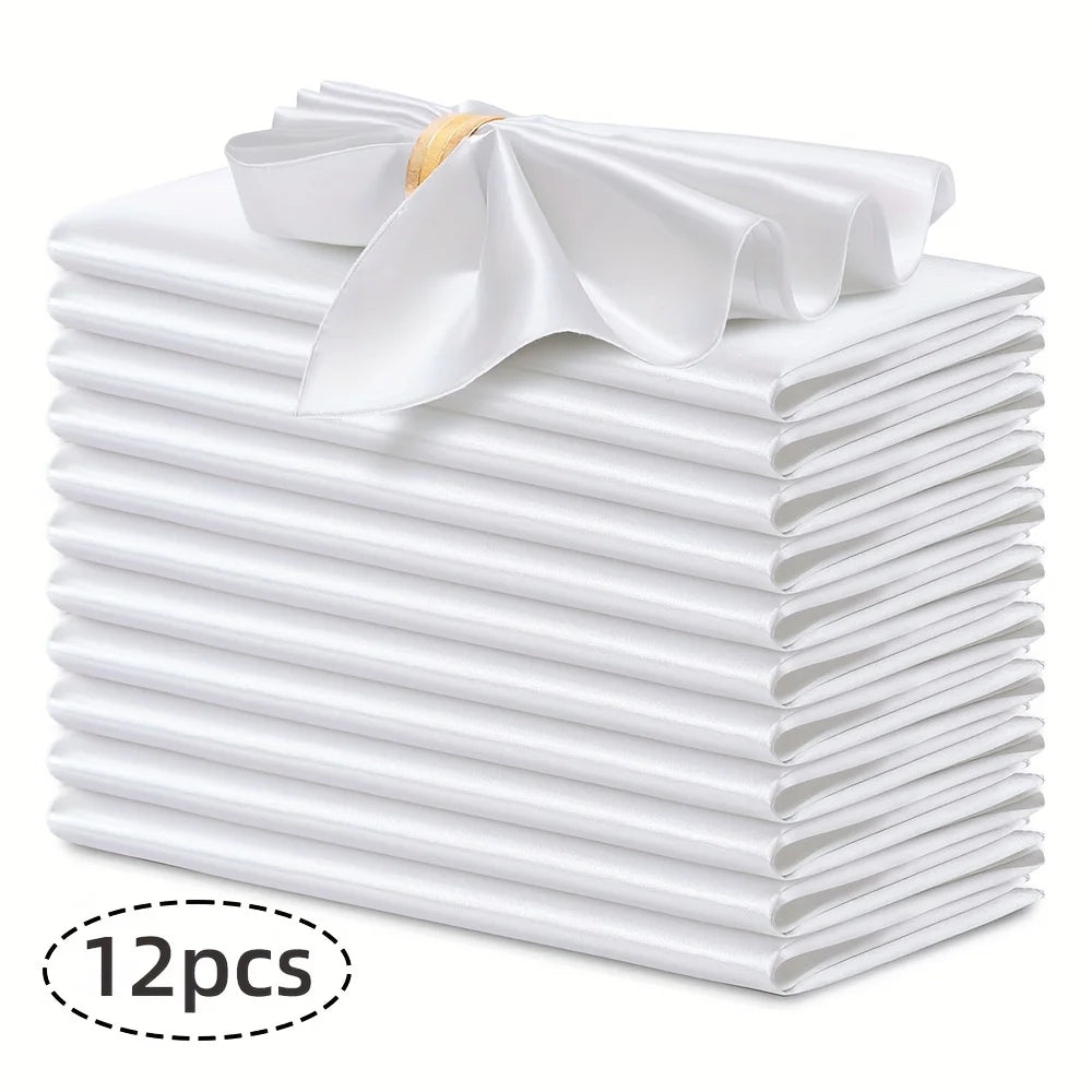 A stack of twelve white silky satin dinner napkins with a decorative bow on top.