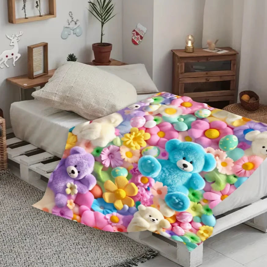 A colorful flannel blanket featuring a floral print with various stuffed animals like bears and flowers.