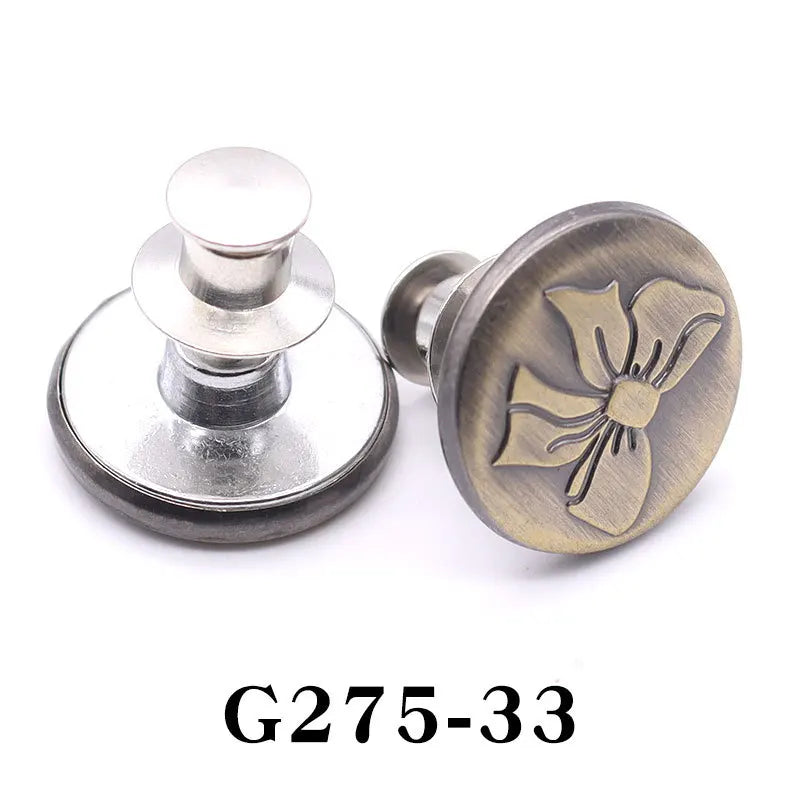 A brass adjustable button pin with a decorative bow design and silver mounting hardware.