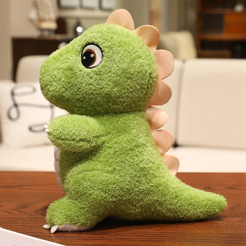 A soft, bright green dinosaur plush toy with a textured skin and a spiky tail is shown on a wooden surface.