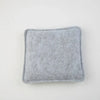 A square, gray needle felting mat pad with rounded edges.